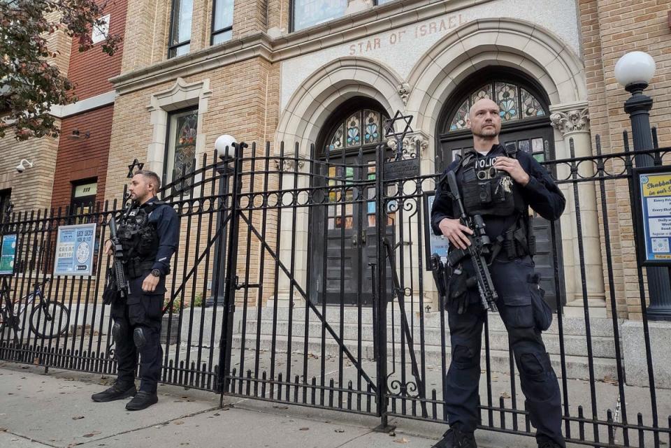 Hoboken Police officers stand watch outside the United Synagogue of Hoboken in New Jersey on Thursday (Associated Press)