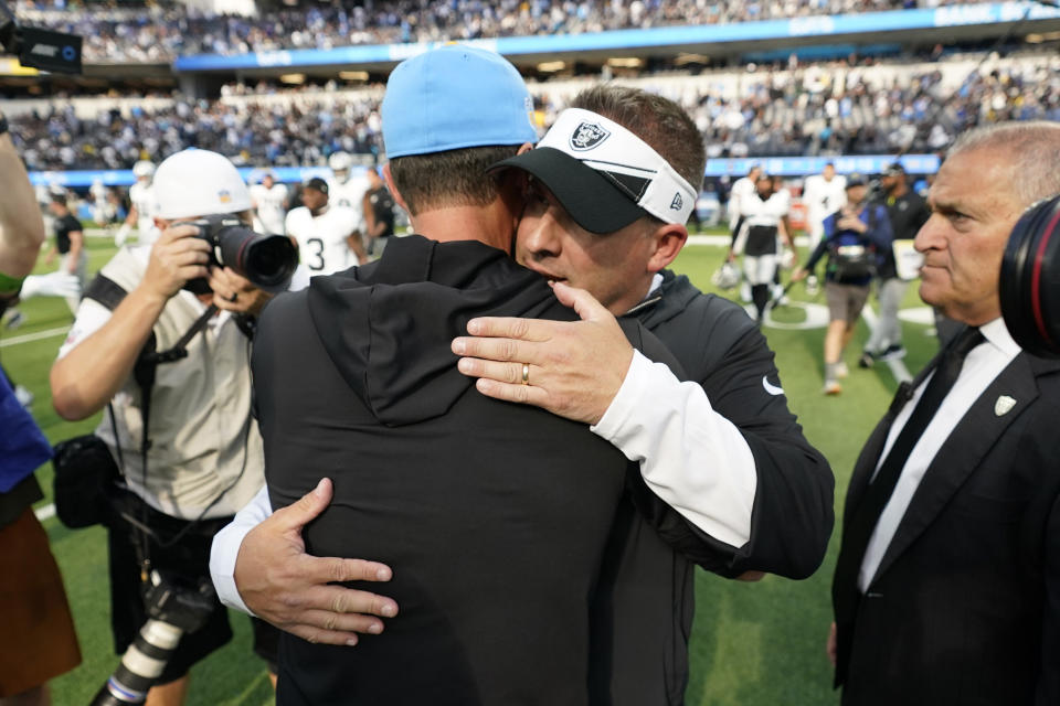 Las Vegas Raiders head coach Josh McDaniels, right, hugs Los Angeles Chargers head coach Brandon Staley after an NFL football game Sunday, Oct. 1, 2023, in Inglewood, Calif. (AP Photo/Ashley Landis)