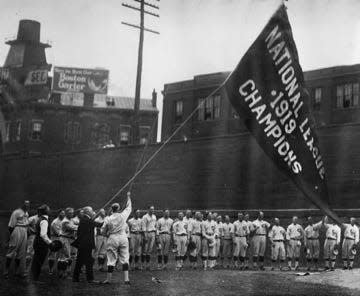 Early in the 1920 season, the Reds players hoisted their "Cincinnati Reds - 1919 - Champions of the World" banner at Redland Field.