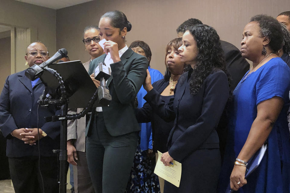 Jazmyne Childs cries during a news conference on Wednesday, Sept. 25, 2019, as she describes the sexual harassment she says she endured while employed by the North Carolina chapter of the NAACP, in Raleigh, N.C. She is asking the national NAACP to expel the man whom she identified as the person who assaulted and harassed her. (AP Photo/Martha Waggoner)