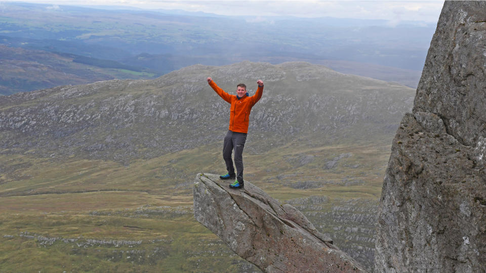 Man wearing Salewa Puez Gore-Tex Paclite Jacket while standing on Cannon Rock on Tryfan, Snowdonia