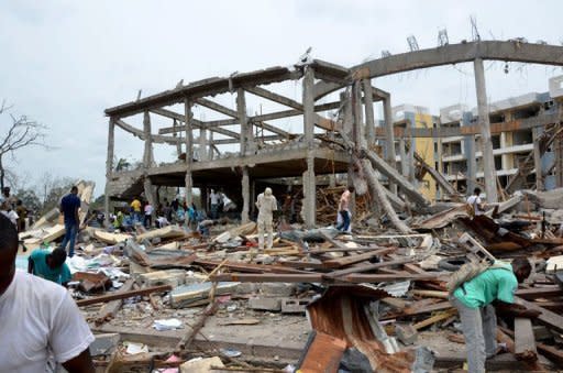 People search the wreckage of Saint Louis Church in the Mpila district of Brazzaville. The death toll from powerful explosions at a Congo munitions dump approached 200 on Tuesday, as international aid began to arrive to help treat over 1,300 wounded and assist 5,000 homeless