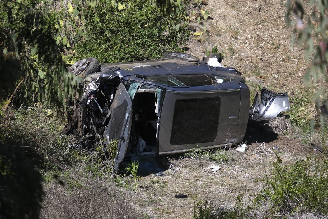 A vehicle rests on its side after a rollover accident involving golfer Tiger Woods along a road in the Rancho Palos Verdes section of Los Angeles on Tuesday, Feb. 23. 