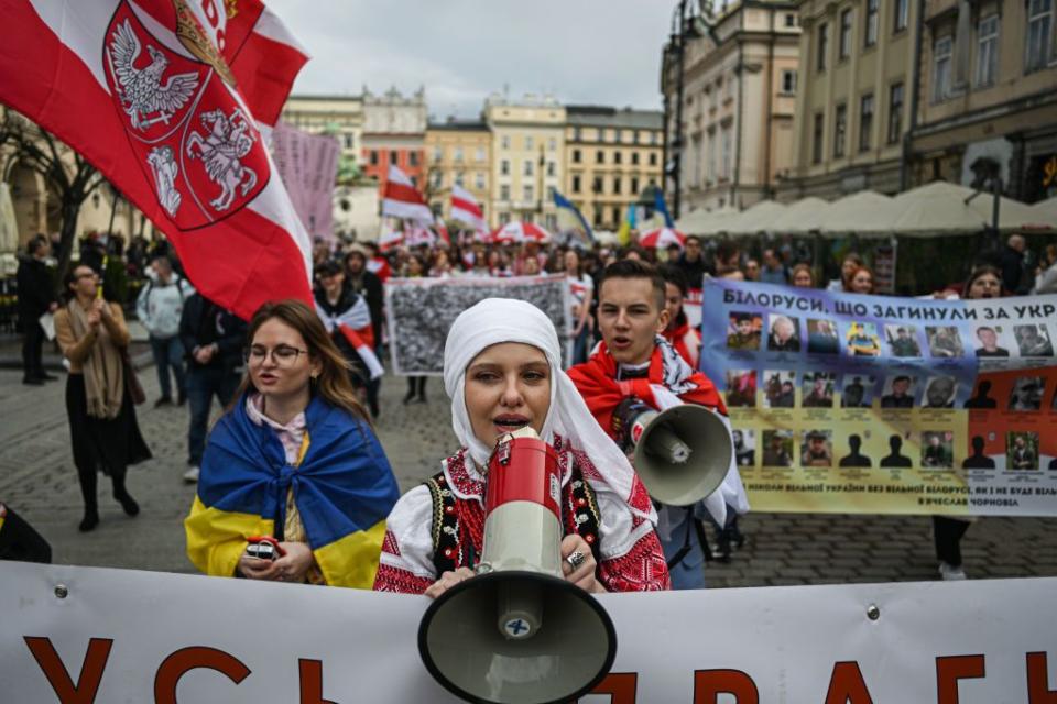 Belarusians hold historical red-white-red flags during the Freedom Day celebrations on March 25, 2023, in Krakow, Poland. (Omar Marques/Anadolu Agency via Getty Images)