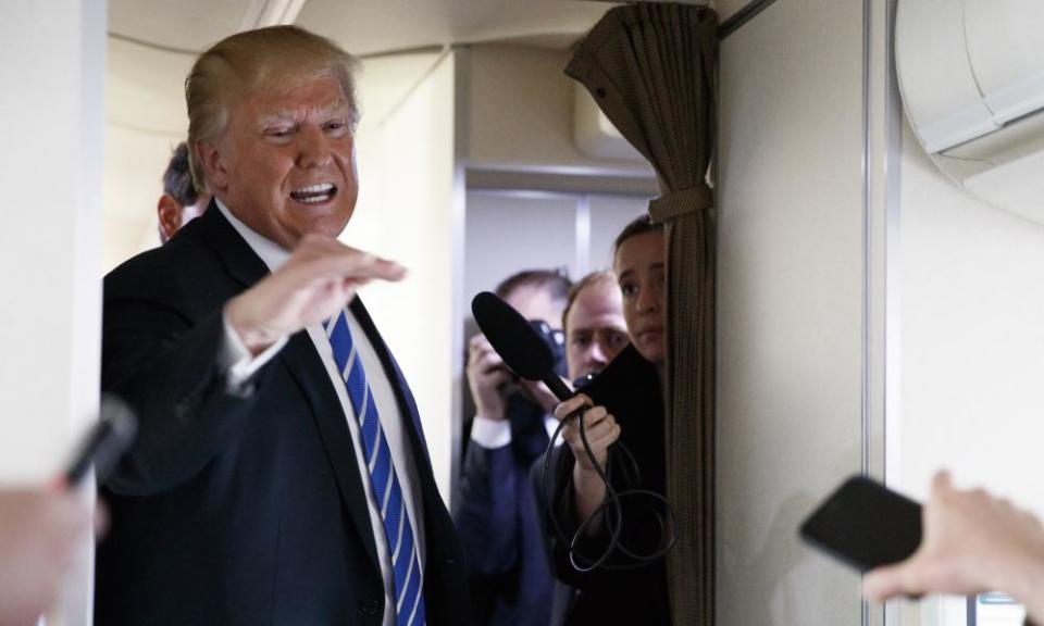 Donald Trump talks with reporters aboard Air Force One on a flight to Andrews air force base, Maryland, on Thursday.