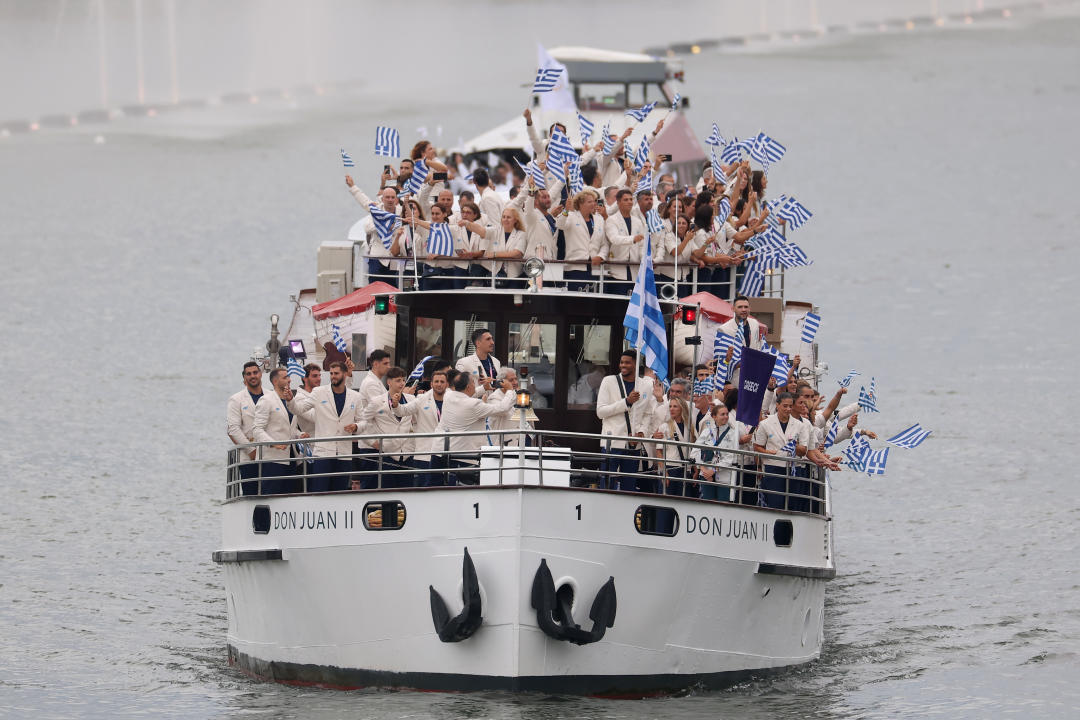 PARIS, FRANCE - JULY 26: Team Greece begins the athletes’ parade past water jets and the water curtain under the Austerlitz Bridge on the Seine during the opening ceremony of the Olympic Games Paris 2024 on July 26, 2024 in Paris, France. (Photo by Lars Baron/Getty Images)