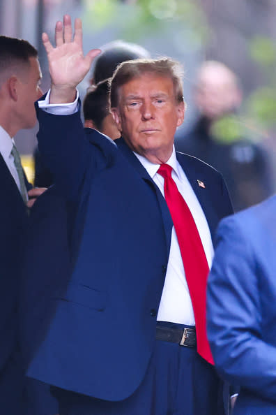 Former US President Donald Trump waves as he departs Trump Tower for Manhattan Criminal Court, to attend the first day of his trial for allegedly covering up hush money payments linked to extramarital affairs, in New York City on April 15, 2024. Trump goes to court Monday as the first US ex-president ever to be criminally prosecuted, a seismic moment for the United States as the presumptive Republican nominee campaigns to re-take the White House. The scandal-plagued 77-year-old is accused of falsifying business records in a scheme to cover up an alleged sexual encounter with adult film actress Stormy Daniels to shield his 2016 election campaign from adverse publicity. (Photo by Charly TRIBALLEAU / AFP) (Photo by CHARLY TRIBALLEAU/AFP via Getty Images)