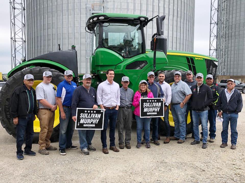 GOP gubernatorial candidate Jesse Sullivan poses with a group at the Prairie Central Cooperative grain elevator between Chenoa and Fairbury Wednesday.