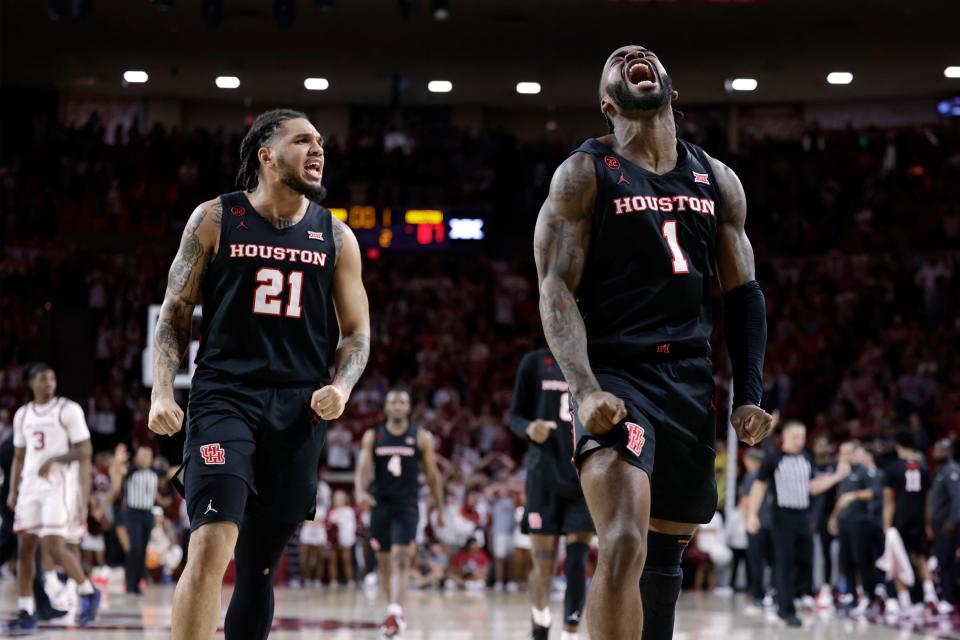 Houston guard Emanuel Sharp (21) and guard Jamal Shead (1) celebrate during the second half of the team's NCAA college basketball game against Oklahoma on Saturday, March 2, 2024, in Norman, Okla. (AP Photo/Garett Fisbeck)