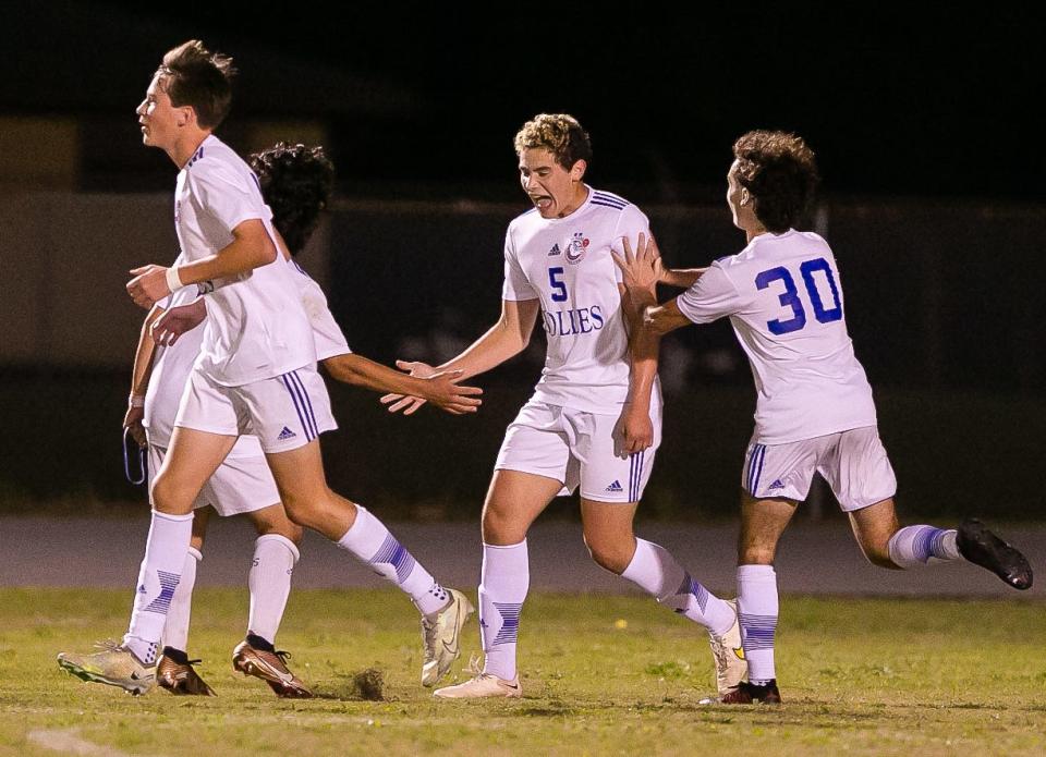 Bolles' Luke Santamaria (5) celebrates his goal with teammates in the 5-2 Class 3A win at Williston.