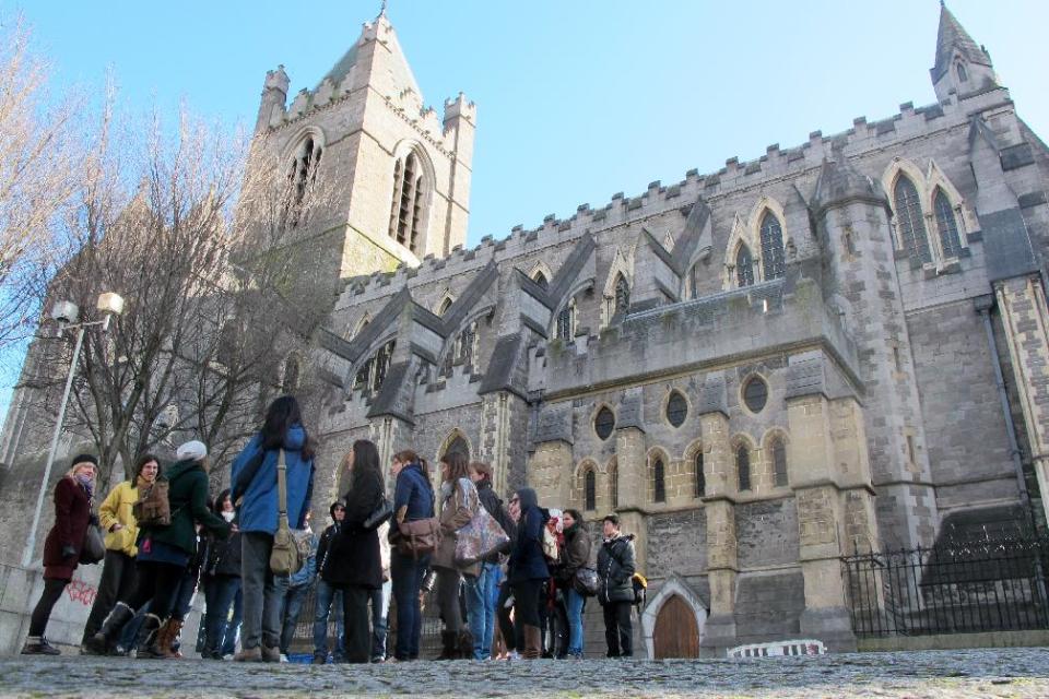 This March 4, 2012 photo shows an American tourist group gathered outside Christ Church Cathedral in Dublin. The 11th-century cathedral is a focal point for tourists exploring the medieval Viking origins of Dublin more than a millennium ago. (AP Photo/Shawn Pogatchnik)