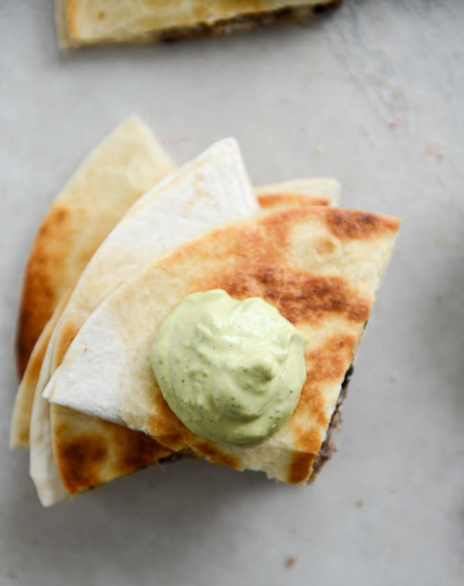 <strong>Get the <a href="http://www.howsweeteats.com/2013/02/cheesy-double-bean-quesadillas-with-homemade-avocado-ranch/" target="_blank">Cheesy Double Bean Quesadillas with Homemade Avocado Ranch recipe </a>from How Sweet It Is</strong>