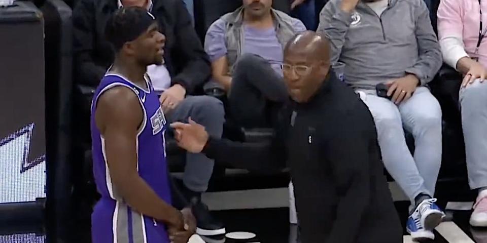 A screenshot shows Mike Brown talking to Terence Davis during a timeout in a game.