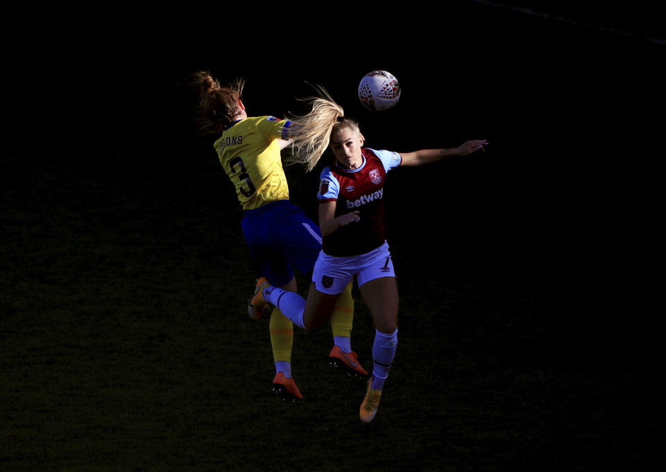 Brighton and Hove Albion's Felicity Gibbons, left, and West Ham United's Alisha Lehmann are caught in sunlight, competing for a header during their Women's Super League soccer match at Chigwell Construction Stadium, in London, Sunday Nov. 15, 2020. (Mike Egerton/PA via AP)