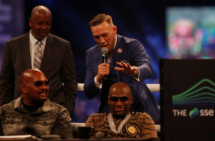 Conor McGregor goes to palm Floyd Mayweather's head in London against the advice of Dana White. (REUTERS)
