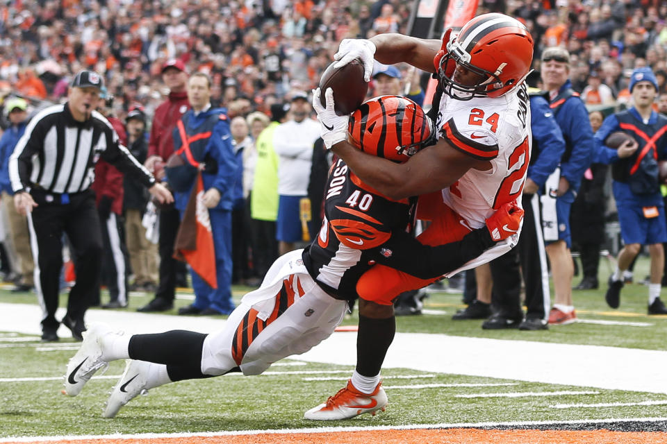 Cleveland Browns running back Nick Chubb (24) catches a touchdown pass against Cincinnati Bengals defensive back Brandon Wilson (40) in the first half of an NFL football game, Sunday, Nov. 25, 2018, in Cincinnati. (AP Photo/Frank Victores)