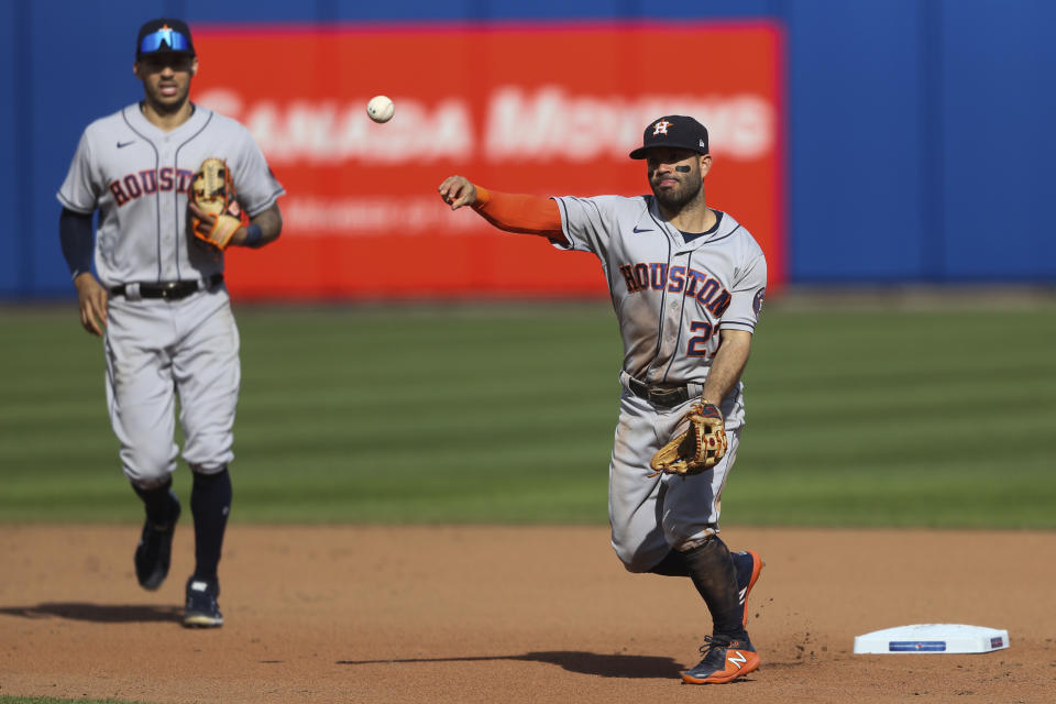 Houston Astros' second baseman Jose Altuve (27) throws to first base to complete a double play on Toronto Blue Jays' Randal Grichuk after forcing out Vladimir Guerrero Jr. at second during the seventh inning of a baseball game in Buffalo, N.Y., Saturday, June 5, 2021. (AP Photo/Joshua Bessex)