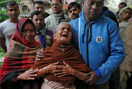 An elderly woman wails as she arrives at the residence of Bablu Santra, a Central Reserve Police Force (CRPF) personnel who was killed after a suicide bomber rammed a car into the bus carrying CRPF personnel in south Kashmir on Thursday, at Bauria village in Howrah district, eastern state of West Bengal, India February 16, 2019. REUTERS/Rupak De Chowdhuri