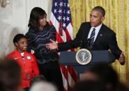 <p>President Barack Obama, with first lady Michelle Obama and Olympic gold medal gymnast Simone Biles speaks in the East Room of the White House in Washington, Thursday, Sept. 29, 2016, after being presented with a surf board signed by the U.S. 2016 Olympians during a ceremony honoring the members of the 2016 United States Summer Olympic and Paralympic Teams. (AP Photo/Manuel Balce Ceneta)</p>