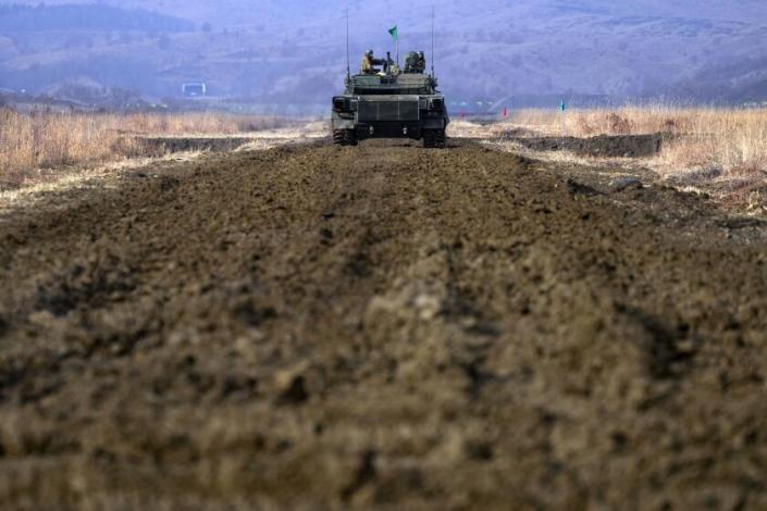 Japanese Ground-Self Defense Force (JGDDF) Type 90 tank drives maneuvers near a target during an annual exercise at the Minami Eniwa Camp Tuesday, Dec. 7, 2021, in Eniwa, Japan's northern island of Hokkaido. Dozens of tanks are rolling over the next two weeks on Hokkaido, a main military stronghold for a country with perhaps the world's most little known yet powerful army. (AP Photo/Eugene Hoshiko)