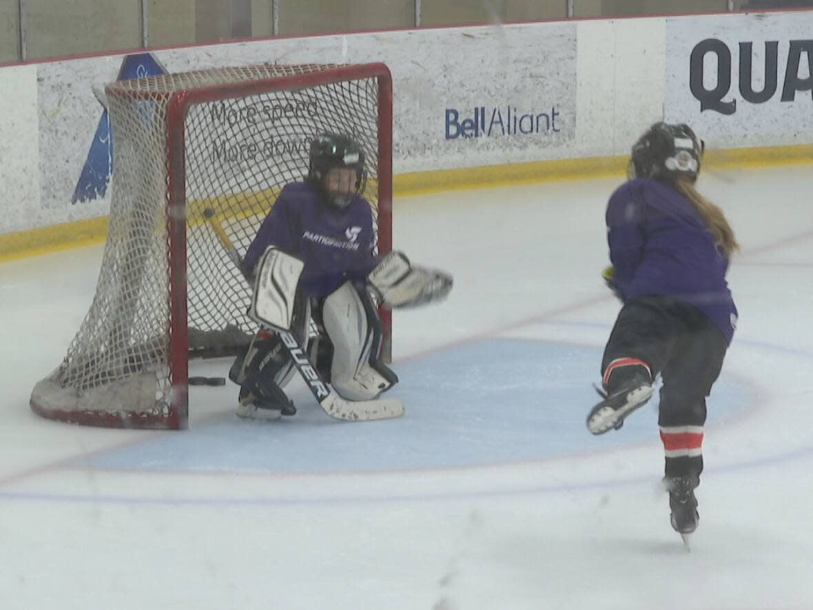 A young player takes a shot on a goalie at the Indigenous Girls Hockey Jamboree in Charlottetown Saturday. (Tony Davis/CBC - image credit)