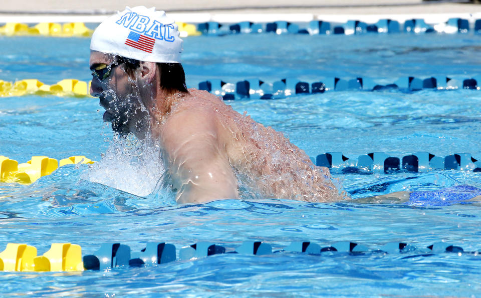 Michael Phelps practices, Wednesday, April 23, 2014, in Mesa, Ariz. Phelps is competing in the Arena Grand Prix at Mesa on Thursday in an attempt to return to swimming professionally. (AP Photo/Matt York)