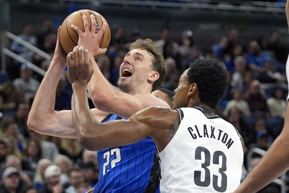 Orlando Magic forward Franz Wagner (22) shoots against Brooklyn Nets center Nic Claxton (33) during the first half of an NBA basketball game, Tuesday, Feb. 27, 2024, in Orlando, Fla. (AP Photo/John Raoux)