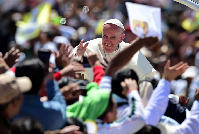 Pope Francis waves from the popemobile in San Cristobal de Las Casas on February 15, 2016