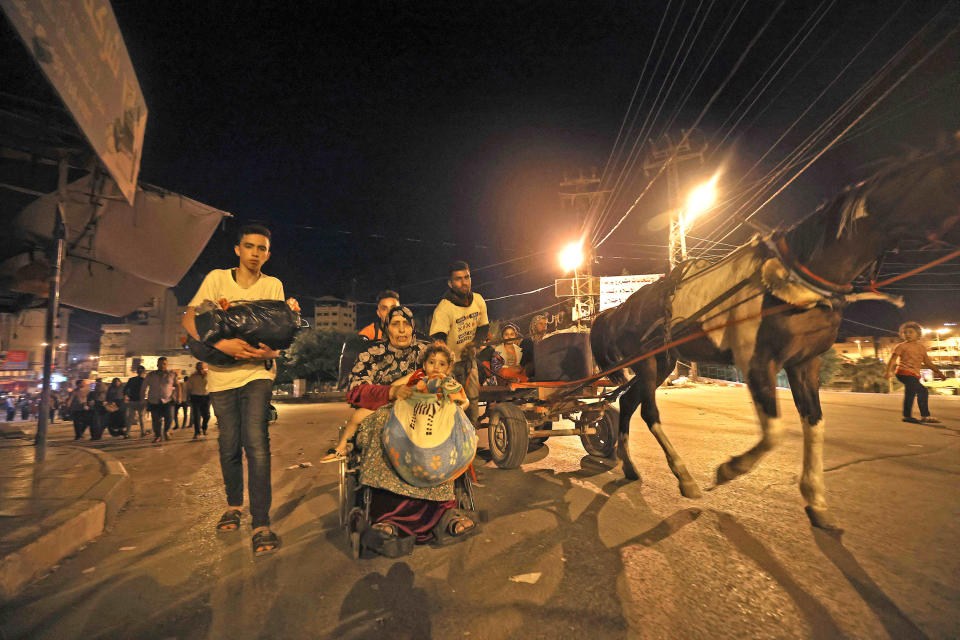 Image: Palestinian families are pictured in a street after evacuating their homes east of Gaza City (Mohammed Abed / AFP - Getty Images)