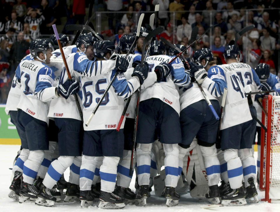 Finland's players celebrate after winning the Ice Hockey World Championships semifinal match between Russia and Finland at the Ondrej Nepela Arena in Bratislava, Slovakia, Saturday, May 25, 2019. (AP Photo/Ronald Zak)
