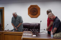 Uvalde Mayor Don McLaughlin, Jr., left, and members of the city council pray during a special emergency city council meeting to reissue the mayor's declaration of local state of disaster due to the recent school shooting at Robb Elementary School, Tuesday, June 7, 2022, in Uvalde, Texas. (AP Photo/Eric Gay)