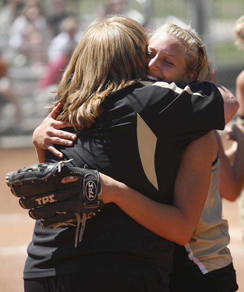 Pitcher Nikki Armagost, senior from Andover Central, hugs her coach Rita Frakes after the Jaguars won the 2009 softball state championship game at the Hummer Sports Complex Field in Topeka.