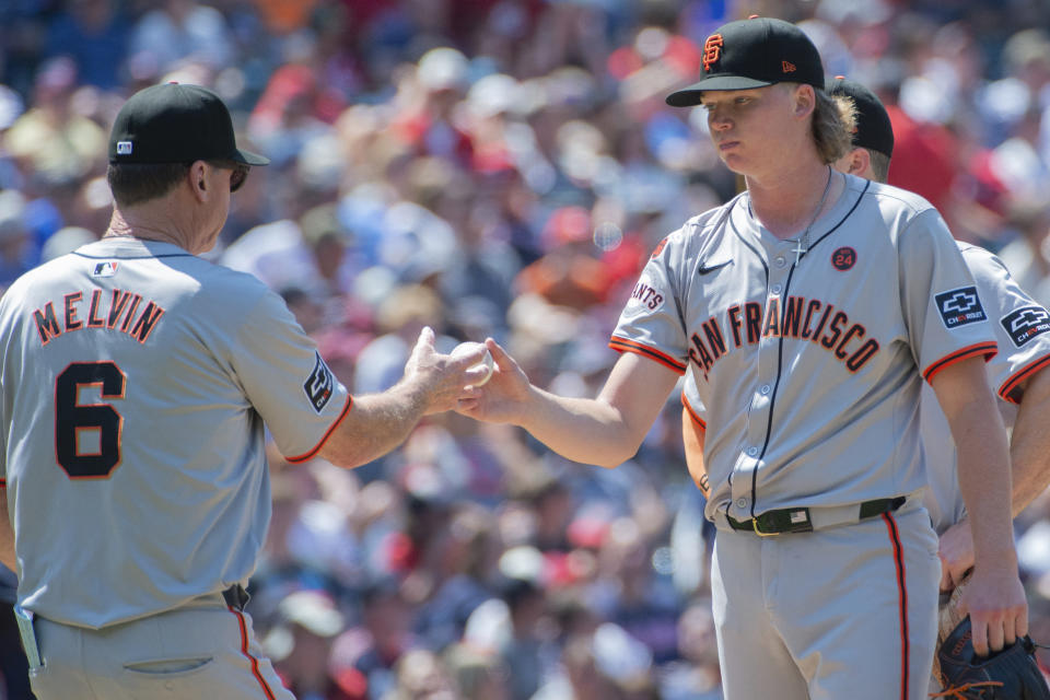 San Francisco Giants manager Bob Melvin (6) takes the ball from starting pitcher Hayden Birdsong, right, during the fifth inning of a baseball game against the Cleveland Guardians in Cleveland, Sunday, July 7, 2024. (AP Photo/Phil Long)