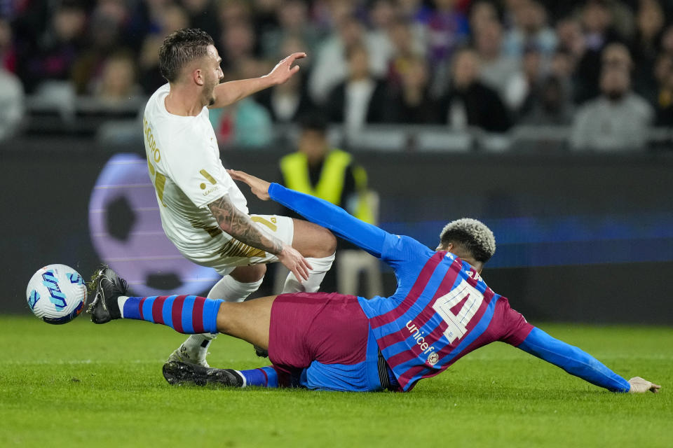 Barcelona's Ronald Araujo, right, talks A-League All Stars' Reno Piscopo during their friendly soccer match at Stadium Australia in Sydney, Australia, Wednesday, May 25, 2022. (AP Photo/Rick Rycroft)