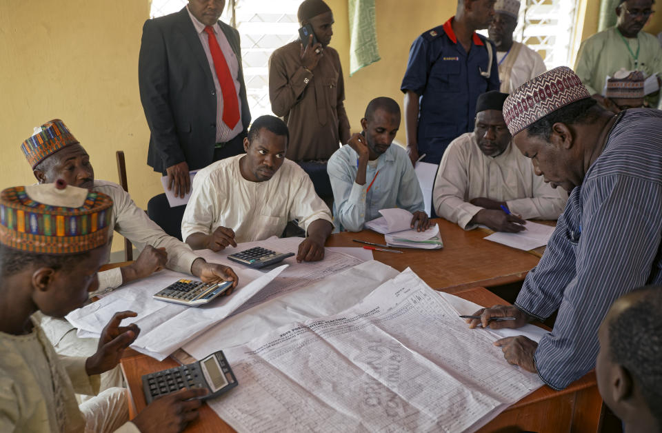 Electoral officials compile voting results at a collation center in Kano, northern Nigeria Sunday, Feb. 24, 2019. Vote counting continued Sunday as Nigerians awaited the outcome of a presidential poll seen as a tight race between the president and a former vice president. (AP Photo/Ben Curtis)