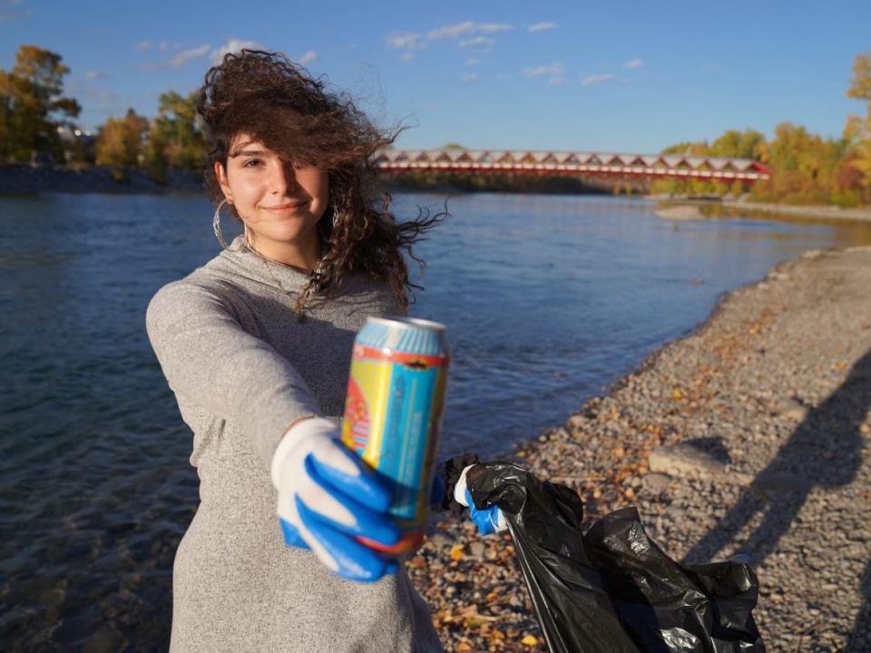 University of Calgary student Angelina Hajji has organized a small but mighty group to clean Calgary's river edge every week. (Axel Tardieu/CBC - image credit)