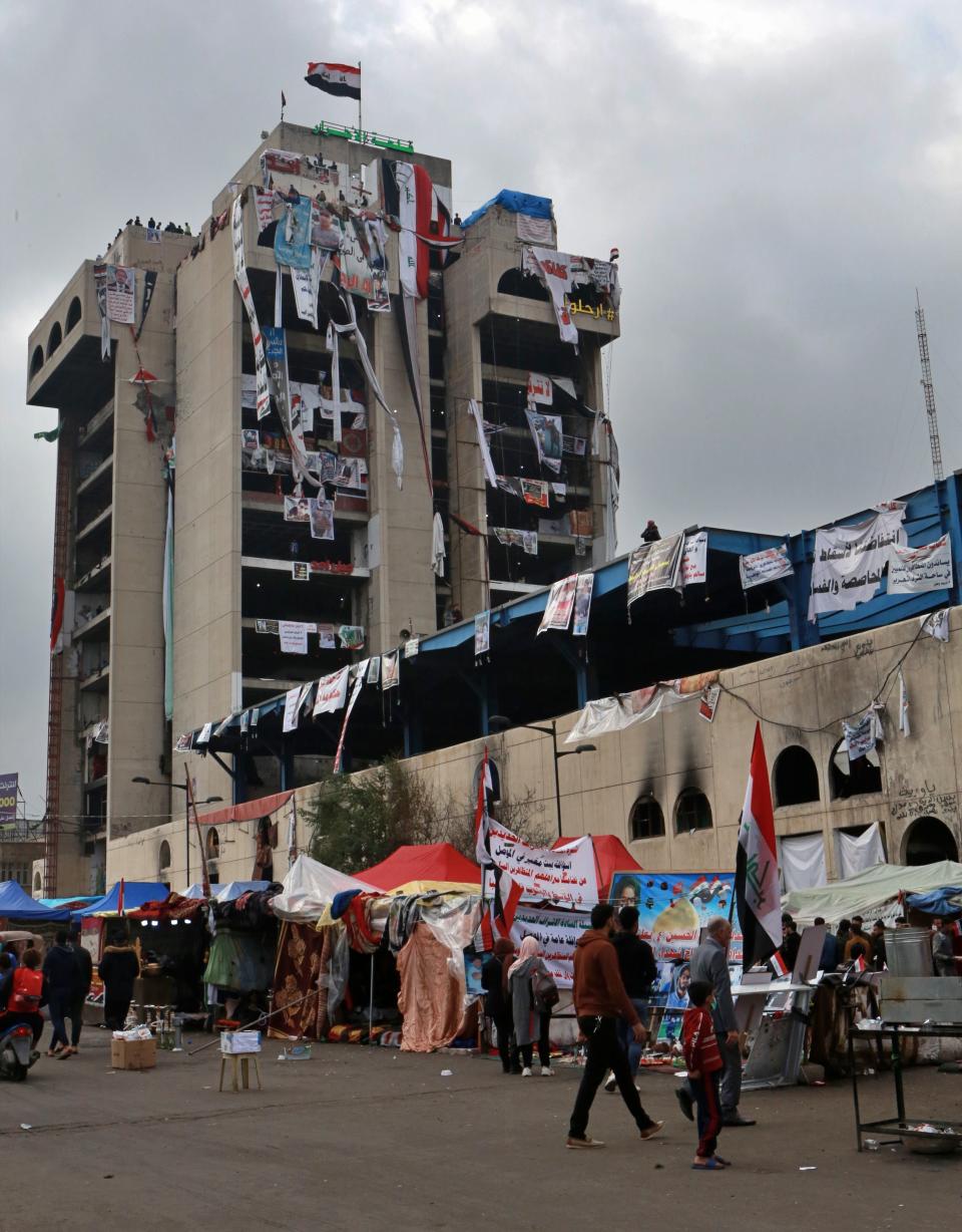 Demonstrators gather at Tahrir Square during ongoing anti-government protests in Baghdad, Iraq, Tuesday, Dec. 3, 2019. At least 400 people have died since the leaderless uprising shook Iraq on Oct. 1, with thousands of Iraqis taking to the streets in Baghdad and the predominantly Shiite southern Iraq decrying corruption, poor services, lack of jobs and calling for an end to the political system that was imposed after the 2003 U.S. invasion. (AP Photo/Hadi Mizban)