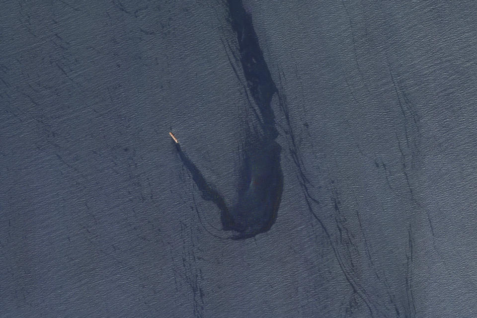 In this satellite image provided by Planet Labs, the Belize-flagged bulk carrier Rubymar is seen in the southern Red Sea near the Bay el-Mandeb Strait leaking oil after an attack by Yemen's Houthi rebels Tuesday, Feb. 20, 2024. Despite a month of U.S.-led airstrikes, Yemen's Iran-backed Houthi rebels remain capable of launching significant attacks. This week, they seriously damaged a ship in a crucial strait and apparently downed an American drone worth tens of millions of dollars. (Planet Labs PBC via AP)