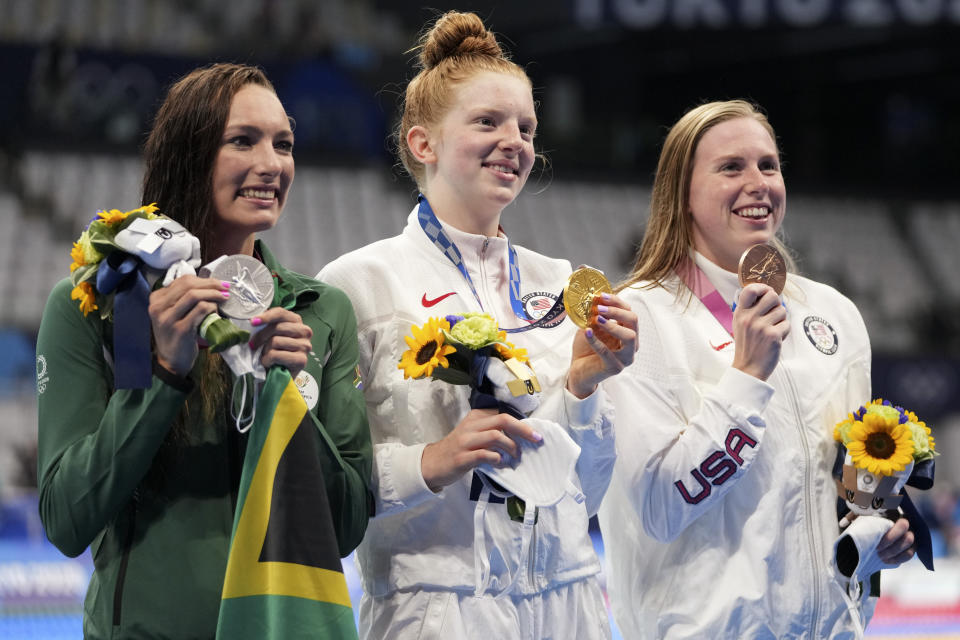 Gold medalist Lydia Jacoby, centre, of the United States, stands with silver medalist Tatjana Schoenmaker, left, of South Africa, and bronze medalist Lilly King, of the United States, after the final of the women's 100-meter breaststroke at the 2020 Summer Olympics, Tuesday, July 27, 2021, in Tokyo, Japan. (AP Photo/Matthias Schrader)