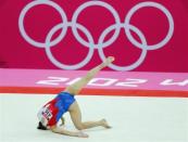 Moldir Azimbay of Kazakhstan falls during her floor exercise during the women's gymnastics qualification at the North Greenwich Arena during the London 2012 Olympic Games July 29, 2012.