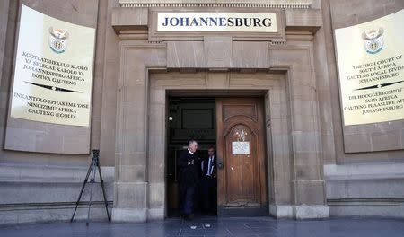 Oscar Pistorius' lawyers Barry Roux (L) and Brian Webber leave after challenging the prosecution's right to appeal the culpable homicide verdict handed down to Pistorius at the Johannesburg High court, March 13, 2015. REUTERS/Siphiwe Sibeko