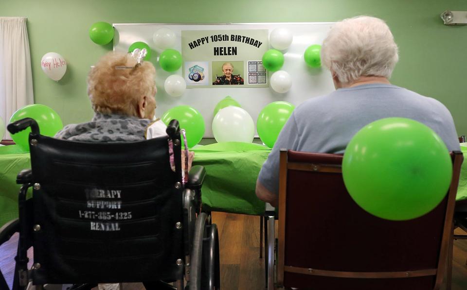 Helen Molnar, left, and her friends enjoy a few rounds of bingo during Helen's 105th birthday party Tuesday at The Landing of Stow.