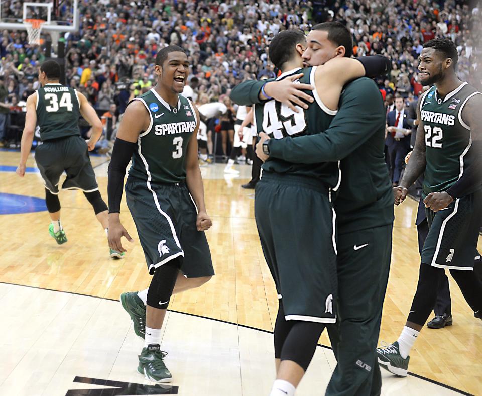 Junior guard Denzel Valentine embraces his brother Drew, an MSU graduate manager, after the Spartans’ victory over Louisville on Sunday.