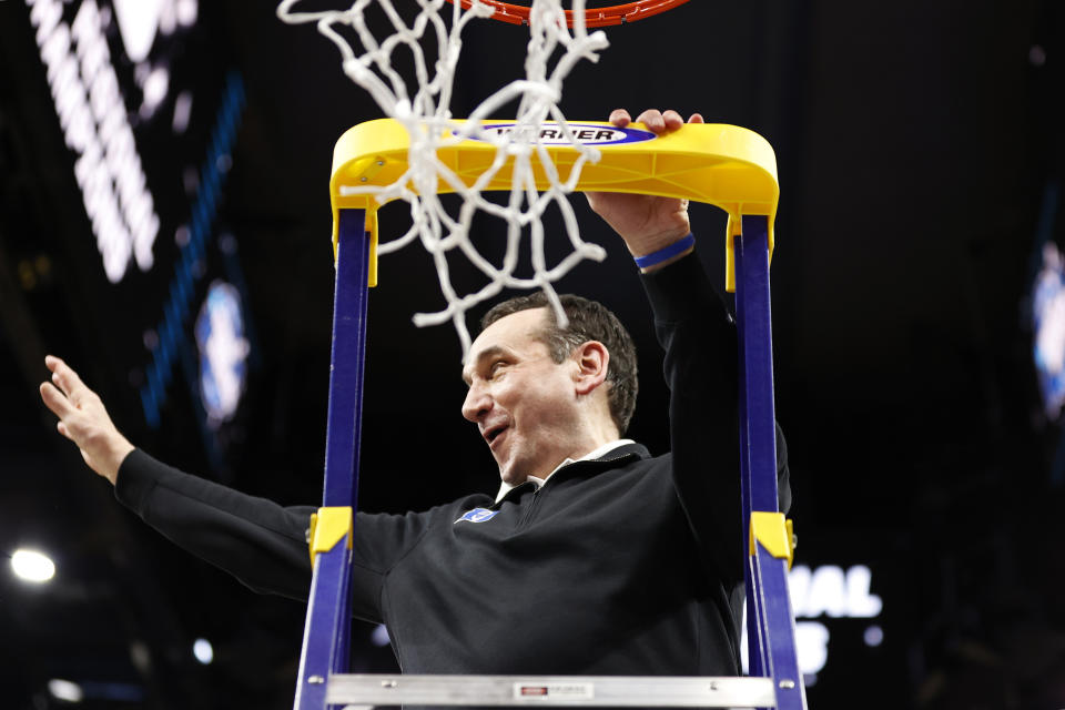 SAN FRANCISCO, CALIFORNIA - MARCH 26: Head coach Mike Krzyzewski of the Duke Blue Devils climbs the ladder to cut down the net after defeating the Arkansas Razorbacks 78-69 during the second half in the NCAA Men's Basketball Tournament Elite 8 Round at Chase Center on March 26, 2022 in San Francisco, California. (Photo by Steph Chambers/Getty Images)