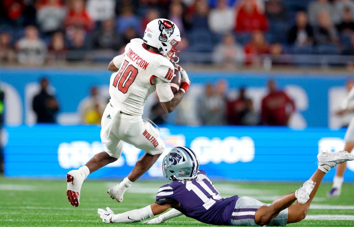 N.C. State wide receiver KC Concepcion (10) makes a 40-yard reception over Kansas State cornerback Jacob Parrish (10) during the second half of Kansas State’s 28-19 victory over N.C. State in the Pop-Tarts Bowl at Camping World Stadium in Orlando, Fla., Thursday, Dec. 28, 2023. Ethan Hyman/ehyman@newsobserver.com