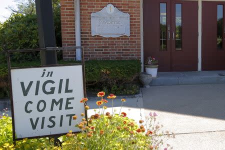 A sign marks the vigil at St. Frances Xavier Cabrini Roman Catholic church in Scituate, Massachusetts July 22, 2015. REUTERS/Brian Snyder