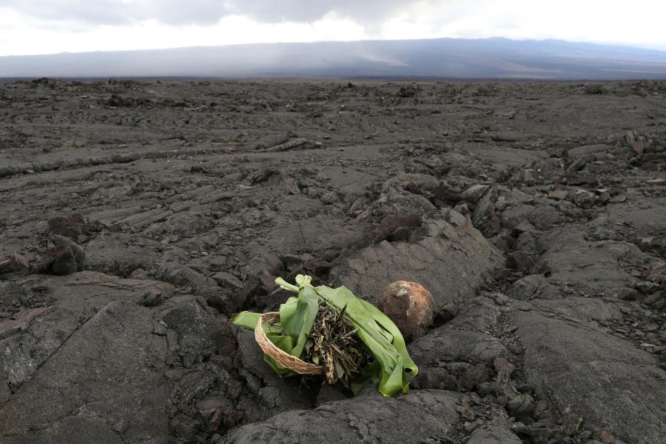 A Native Hawaiian offering is left on an old lava field in front of the erupting Mauna Loa near Hilo, Hawaii, on Nov. 29.