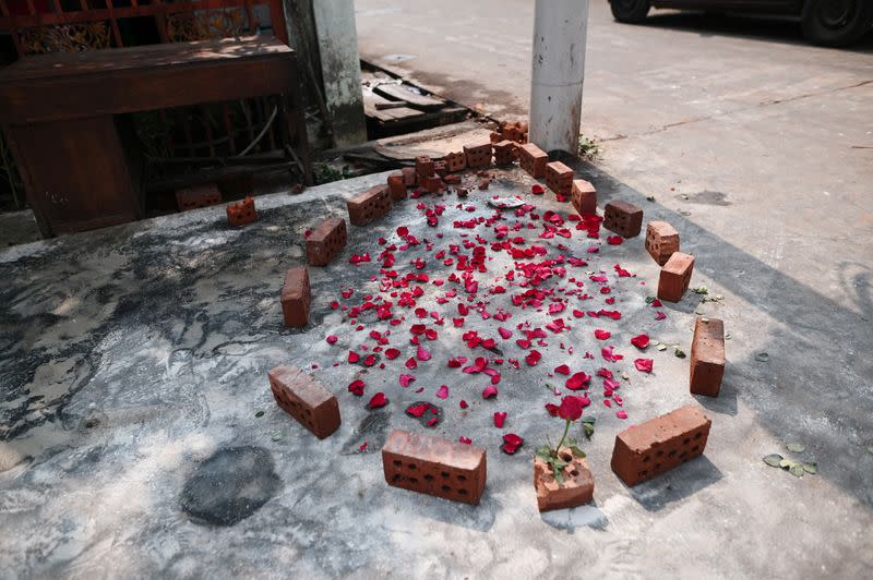 Flower petals are seen at a spot where Aung Than, 41, was killed during a raid by security forces in Thaketa, Yangon