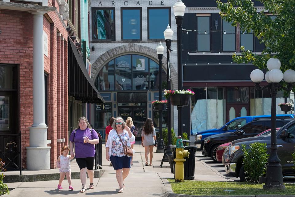 People walk through the town square Wednesday, July 26, 2023, in Lebanon, Tenn. City officials conducted a do-it-yourself census after concern about being under counted by the U.S. Census Bureau in 2020.