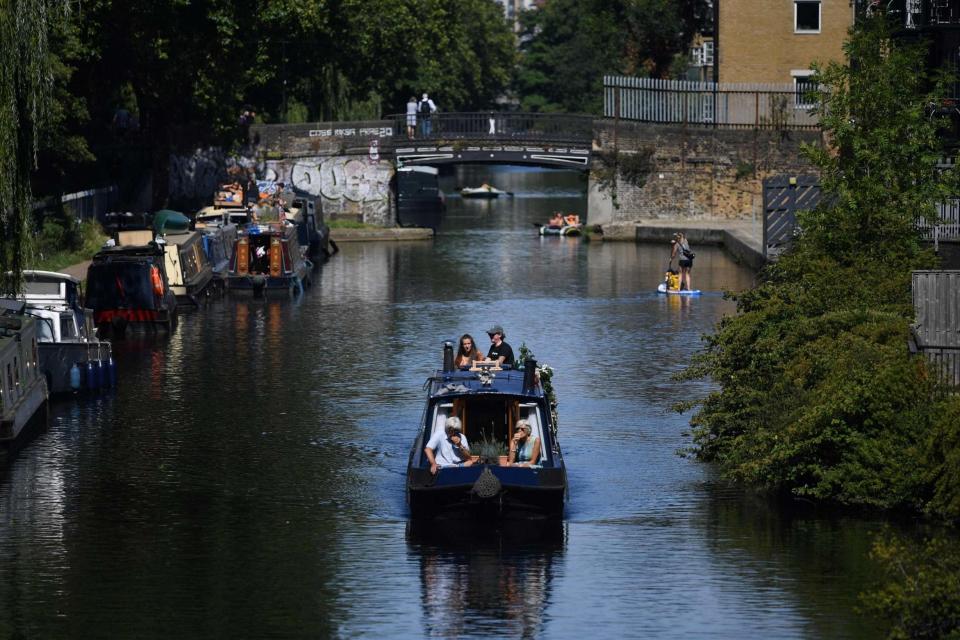 Boaters enjoy the sun at Regent's Canal, near London's Victoria Park (AFP via Getty Images)